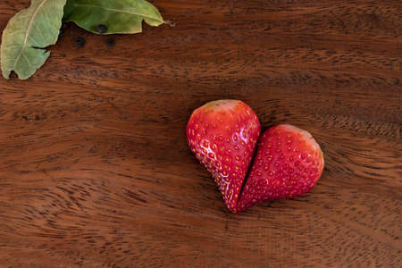 Strawberries cut into a heart shape. Romantic detail for Valentines Dayの写真素材