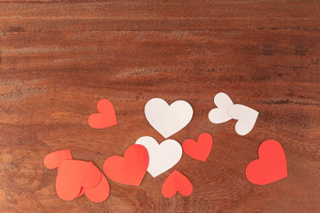 Red and white hearts of different sizes on rustic wooden background for Valentines Dayの写真素材