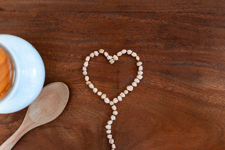Heart-shaped chickpeas on wooden background for valentineの写真素材