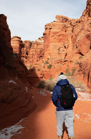Young man hiking between canyons in Arizona, USAの写真素材