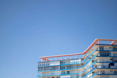 Blue and red building with blue sky in the background