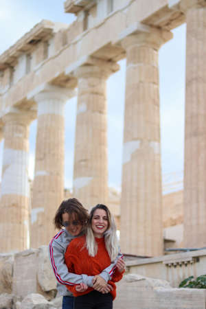 Couple of friends hugging each other at the acropolisの写真素材