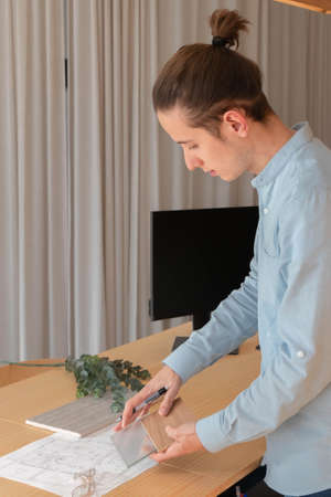 Interior design professional showing material samples to client at the officeの写真素材