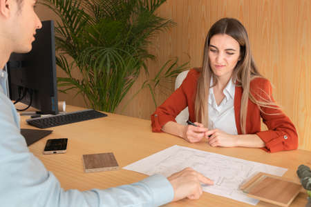 Portrait of woman with a face of disagreement in front of a clientの写真素材