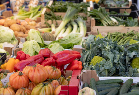 Lots of fresh, fruits and vegetables in wooden boxes at the street marketの写真素材