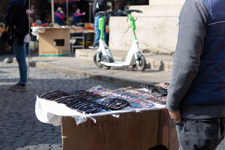 Rome, Italy - March 17th, 2022. Man selling sunglasses at a stall on the streets of Rome, Italyのeditorial素材