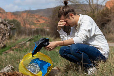 Sad man by humanity and all the garbage that is generated on planet earthの写真素材