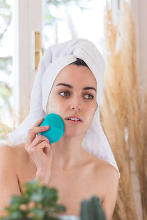 Portrait of woman using creaner for skin treatments as cosmetic procedureの写真素材