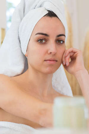 Portrait of beautiful woman with no makeup on with towel rolled upの写真素材