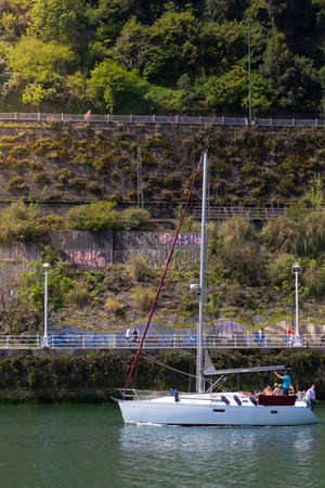 BILBAO, SPAIN-MAY, 5TH, 2022: Veritcal view of boat sailing along the Nervion River in the Zorrozaurre neighborhoodのeditorial素材