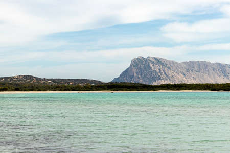 Lu Impostu beach shore with mountain the background and no people, San Teodoro, Sardinia, Italy.の写真素材