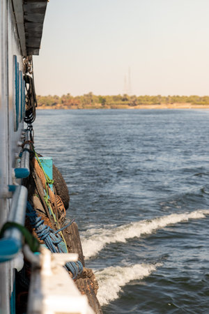 Vertical view of side traditional local boat sailing the river in natural enviromentの写真素材