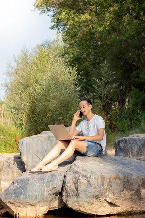 Vertical view of the raw reality of a young white male freelancer working during his retreat in natureの写真素材