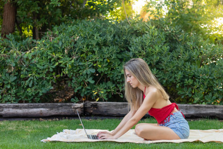 Side view of hard working freelancer working from the outdoor garden with copy space in spring dayの写真素材