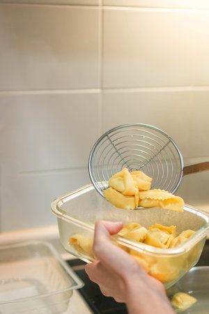 Vertical view of ravioli pasta being cooked in house kitchen for lunchの写真素材