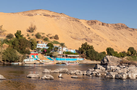 Small traditional old local village in Egypt surrounded by dunes and sand in the river bankの写真素材