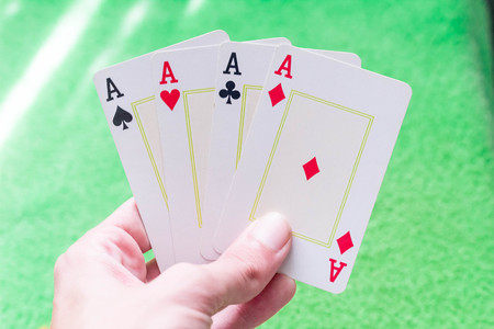 All Aces in Hand with Green Table Backgroundの写真素材