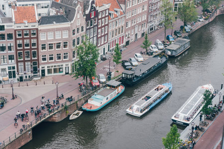 Boats in Amsterdam canal seen from above and houses. Typical view.のeditorial素材