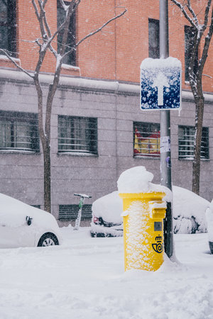 Madrid, Spain - January 2021: mailbox of Spanish postal service Correos covered in snow due to...