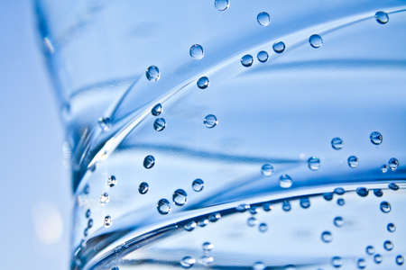 Blue bottle of pure water with bubbles