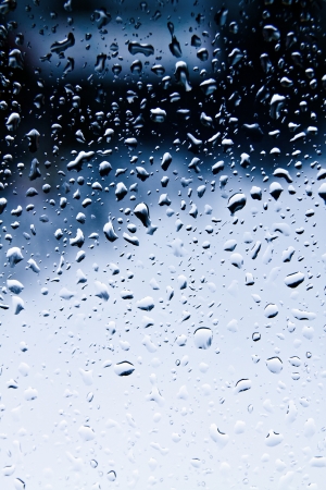 Many raindrops on blue light window glassの写真素材