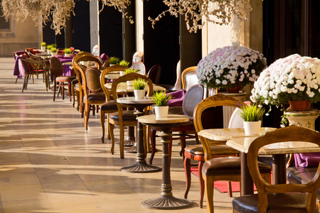 Vintage cafe in Cracow with tables and chairsの写真素材