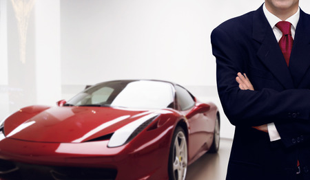 Car dealer presenting vehicle in showroom store