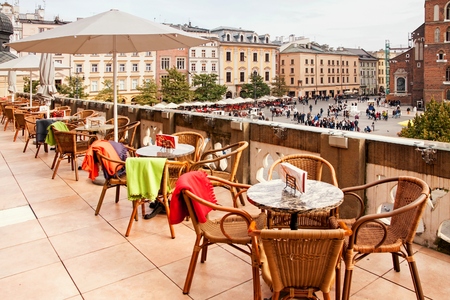 Sukiennice terrace cafe in Cracow with tables and chairsの写真素材