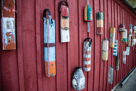 Lobster buoys hung on a wall in a New England town.の写真素材