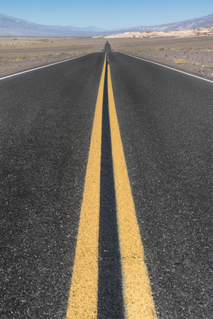 Long straight road in the desert of Death Valley, Californiaの写真素材