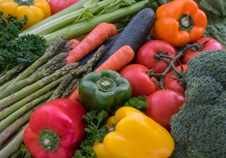 Fresh raw vegetables - tomatoes, peppers, carrots, broccoli, asparagus, celeryの写真素材