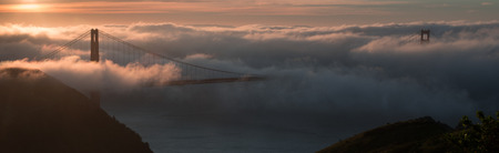 Sunrise and fog over the Golden Gate Bridge in San Francisco, Californiaの写真素材
