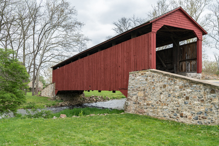 Red covered bridge in the rural countryside of Lancaster County, Pennsylvania.