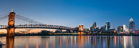 John A. Roebling Suspension Bridge and Cincinnati skyline at night from across the Ohio Riverの写真素材