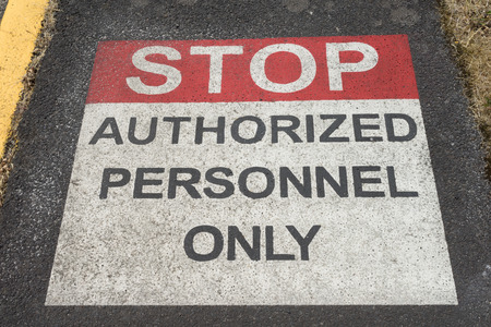 Stop Authorized Personnel Sign painted on sidewalk