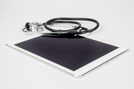 Tablet Computer with Stethoscope on a White Backgroundの写真素材