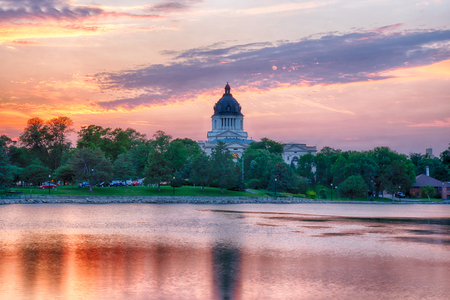 PIERRE, SD: South Dakota Capital Building along Capitol Lake in Pierre, SD at sunsetの写真素材