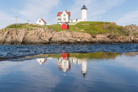 Reflection of Historic Nubble Lighthouse on Cape Neddick in York, Maineの写真素材