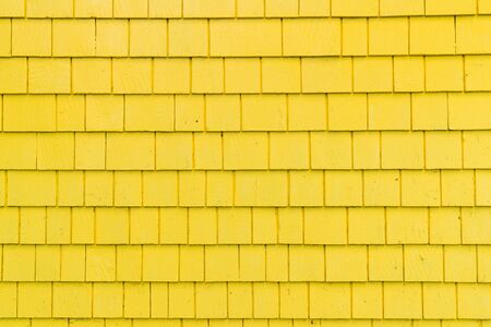 Exterior wall with bright yellow shingles