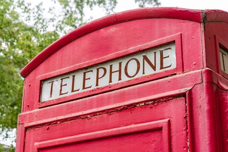 Old red British retro style telephone booth