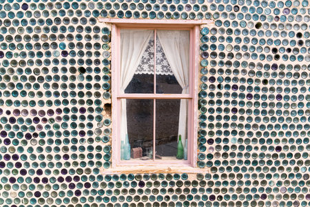 Rhyolite, NV,  - March 4, 2022 : Window on unique house constructed of bottles by Tom Kelly in 1906 in the mining town of Rhyolite, Nevadaのeditorial素材