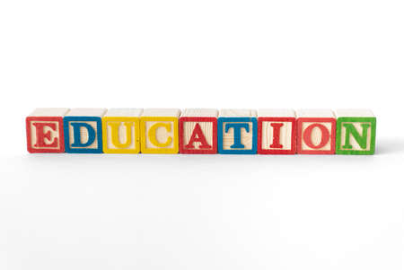 The word Education spelled with colorful toy blocks on a white backgroundの写真素材