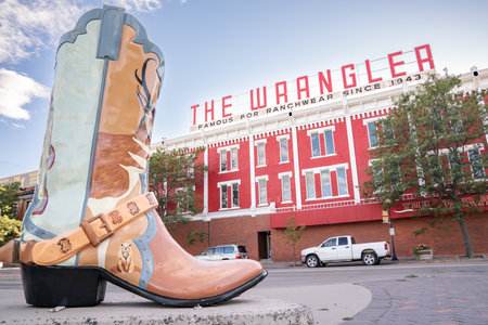 CHEYENNE, Wyoming - APRIL 27, 2018: Sign on top of The Wrangler in historic downtown Cheyenne Wyoming. The three story red-painted brick building dominates a corner of Capitol Avenue and Lincoln Way.のeditorial素材