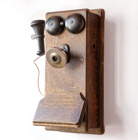Old antique obsolete wooden wall mounted telephone
