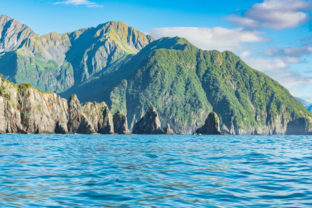 Mountains and sea stacks along the rugged coastline of Resurrection Bay near Seward, Alaskaの写真素材