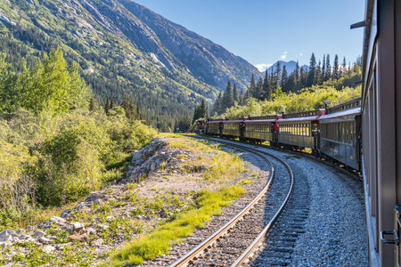 Skagway, AK - September 7, 2022: The White Pass and Yukon Route train winds it's way through the mountains east of Skagway.のeditorial素材