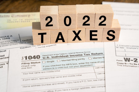 2022 Tax reminder in wooden blocks with IRS Formsの写真素材