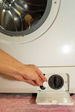 washing machine filter cleaning. the filter in the washing machine is dirtyの写真素材