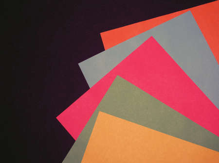 sheets of paper of different colors on a black background.の写真素材