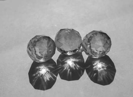 Refraction and reflection of light casts shade and shadow on white paper background. Sparkling glass...